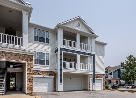 a house with two garages and two cars in front of it