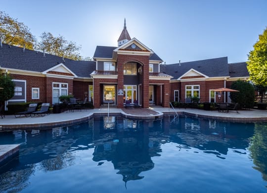a large swimming pool in front of a house