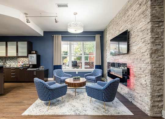 A living room with a stone wall and a fireplace.