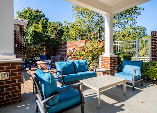 the preserve at ballantyne commons spacious patio with blue chairs and tables
