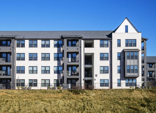 a large apartment building with two towers on top of a hill