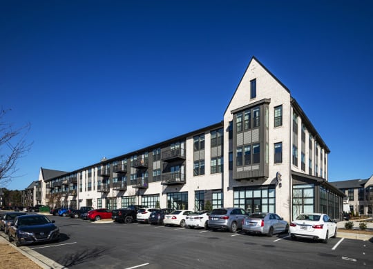 a large building with cars parked in a parking lot