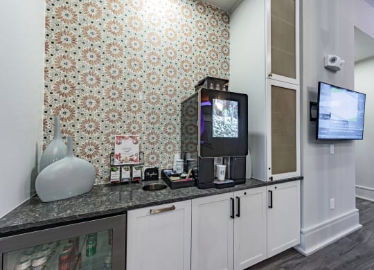 a kitchen with a counter top and a tv
