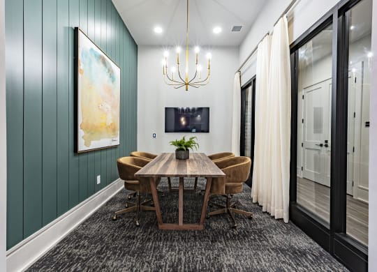 a dining room with a wooden table and chairs and a chandelier