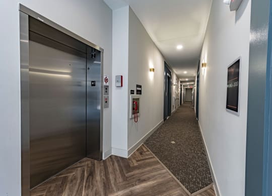 a hallway with elevators and doors in a building