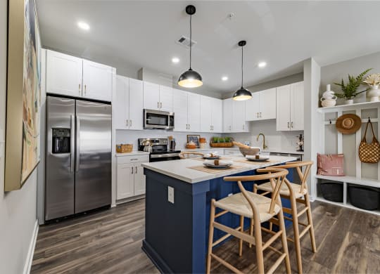 kitchen with island with stools and a stainless steel refrigerator
