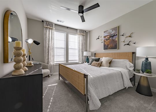 a bedroom with a bed and a dresser and a window