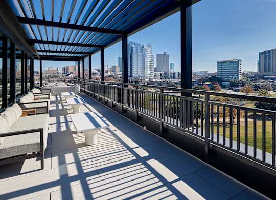 A long balcony with a view of the city.