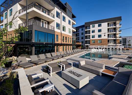 A modern building with a pool in front.