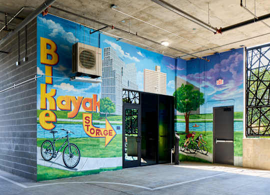 A mural on a wall with a bicycle and the words