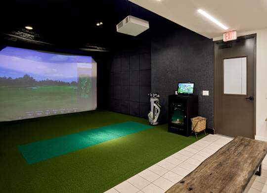 A room with a green mat and a wooden bench.