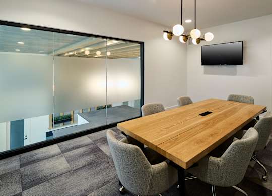 A conference room with a long table and chairs.