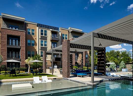 A modern building with a pool in front.