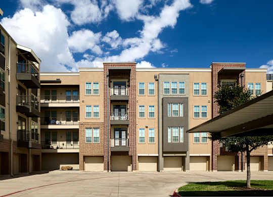 A large building with a parking lot in front.