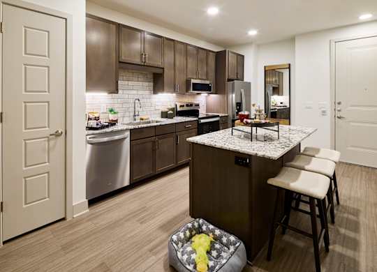 A kitchen with a white fridge and a white dishwasher.