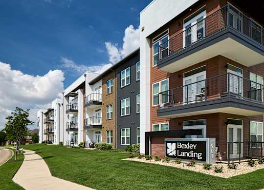 A modern apartment complex with the name Bexley Landing on the sign in front.