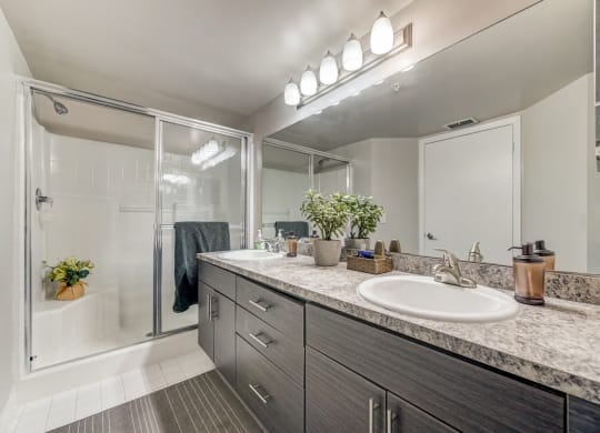 Bathroom with double sinks and walk in shower at Pembroke Pines Landings, Pembroke Pines, FL, 33025