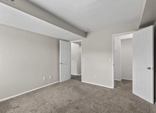 Bedroom with a carpeted floor and two doors at Creve Coeur, Creve Coeur, MO
