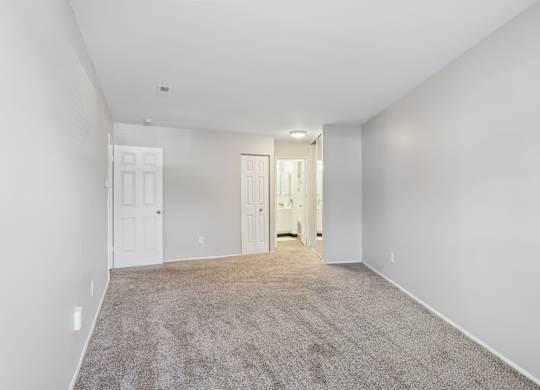 A spacious room with carpeted floor and white walls. at Millennium at Creve Coeur, Missouri