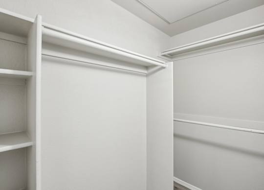 A white closet with shelves and a door at Sweetwater At Metro North Apartments, Phoenix, Arizona