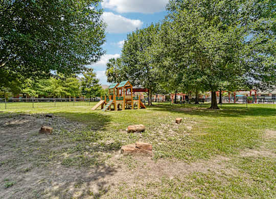 A playground with a slide and a tree.