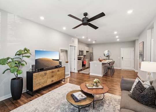 A living room with a ceiling fan and a couch.