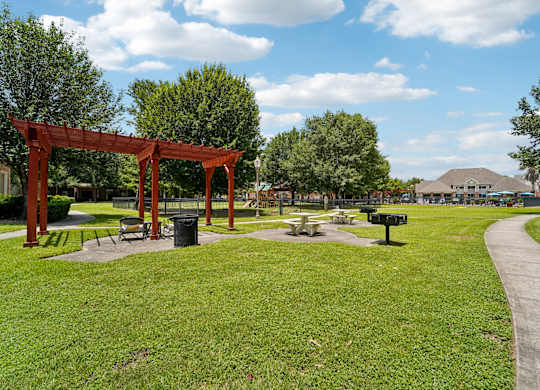 A park with a red structure and a pathway.