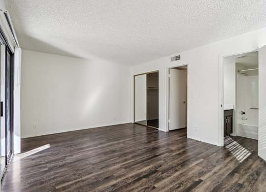 A room with wooden floors and white walls.