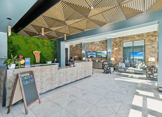 A reception area with a green wall and a blackboard.