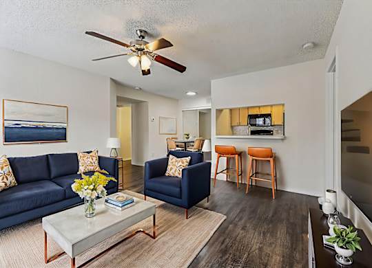 A living room with a blue couch and a coffee table.