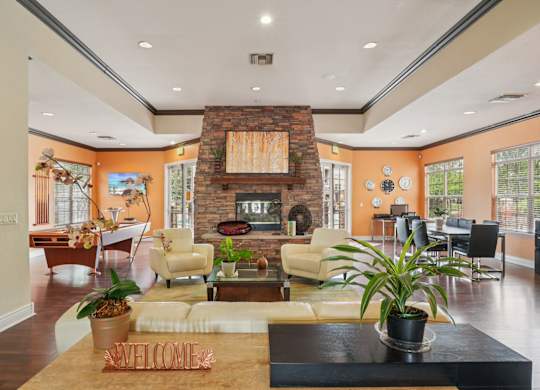 A living room with a fireplace and a welcome mat.