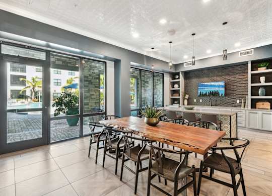 A modern dining room with a wooden table and chairs.