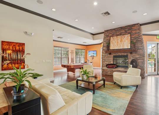 A living room with a fireplace and a painting on the wall.