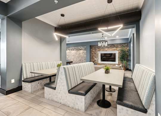 A modern dining area with a long table and chairs.