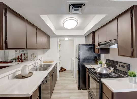 a kitchen with dark cabinets and white countertops at Glen at Mesa Apartments, AZ 85201