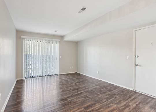 A room with wooden floors and a white door. at Millennium at Creve Coeur, Creve Coeur