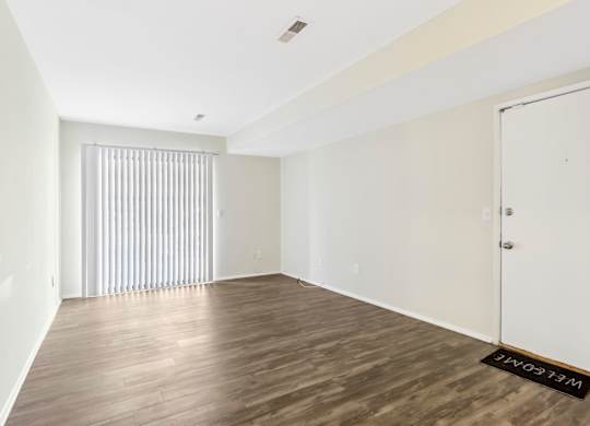 A room with wooden flooring and a white door. at Millennium at Creve Coeur, Missouri, 63141