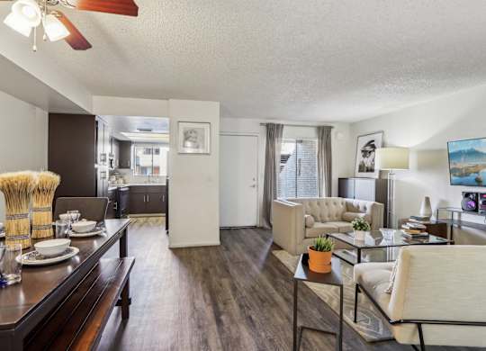 A living room with a dining table and chairs.