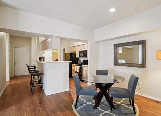 A modern kitchen with a dining table and chairs.