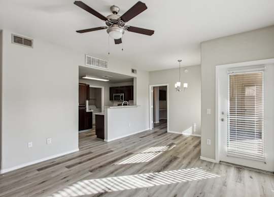 A room with a ceiling fan and wooden flooring at Sweetwater At Metro North Apartments, Phoenix