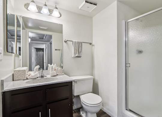 A white toilet sits next to a sink in a bathroom.