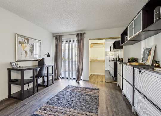 A room with a desk and a chair in it.