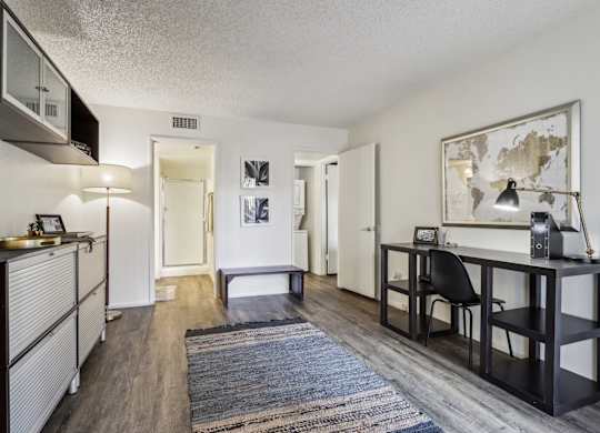 A room with a desk and a chair in it.