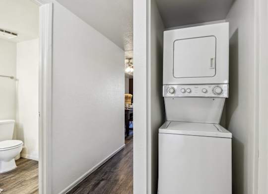 A white toilet with a tank built into a wall.