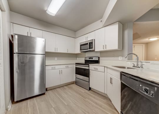 Kitchen with white cabinetry at Pembroke Pines Landings, Pembroke Pines, FL, 33025