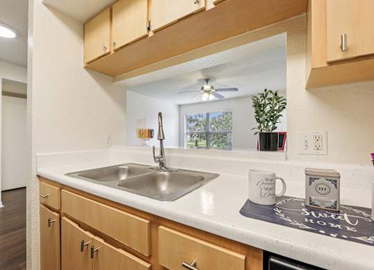A kitchen with wooden cabinets and a white countertop.