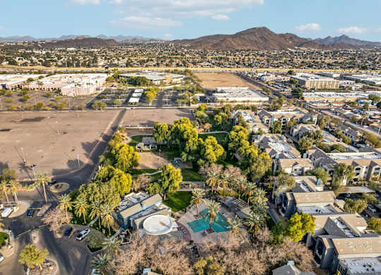 A large open field with a few trees and a building in the distance at Sweetwater At Metro North Apartments, Phoenix, AZ 85029