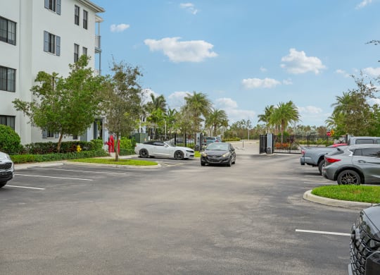 a parking lot with cars parked in front of a building at Edge75, Naples, Florida 34104