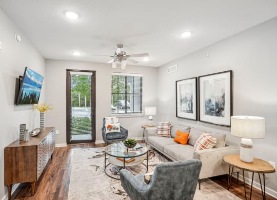 a living room with a couch and chairs and a ceiling fan at Edge75, Naples, Florida 34104