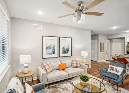 a living room with a couch and a ceiling fan at Edge75, Naples, Florida 34104
